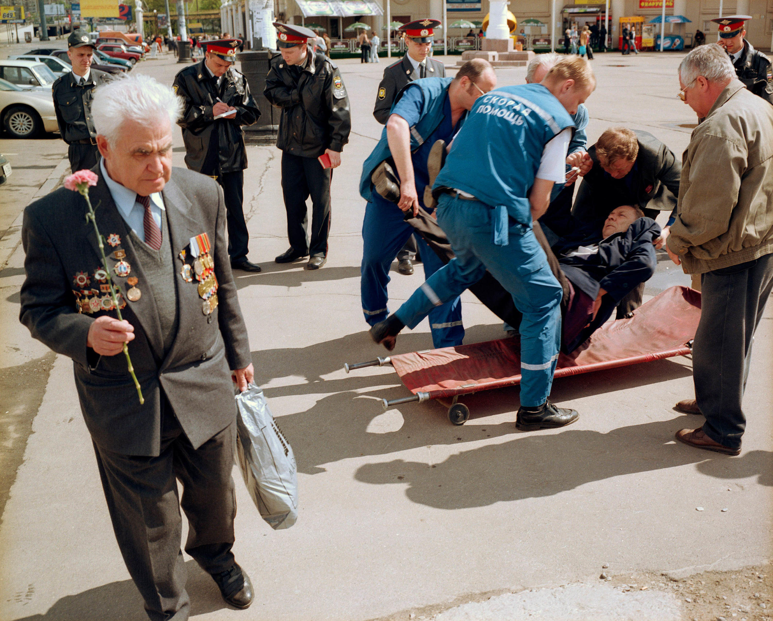 Russia, Moscow. Victory Day. A veteran who has been taken ill is carried away.