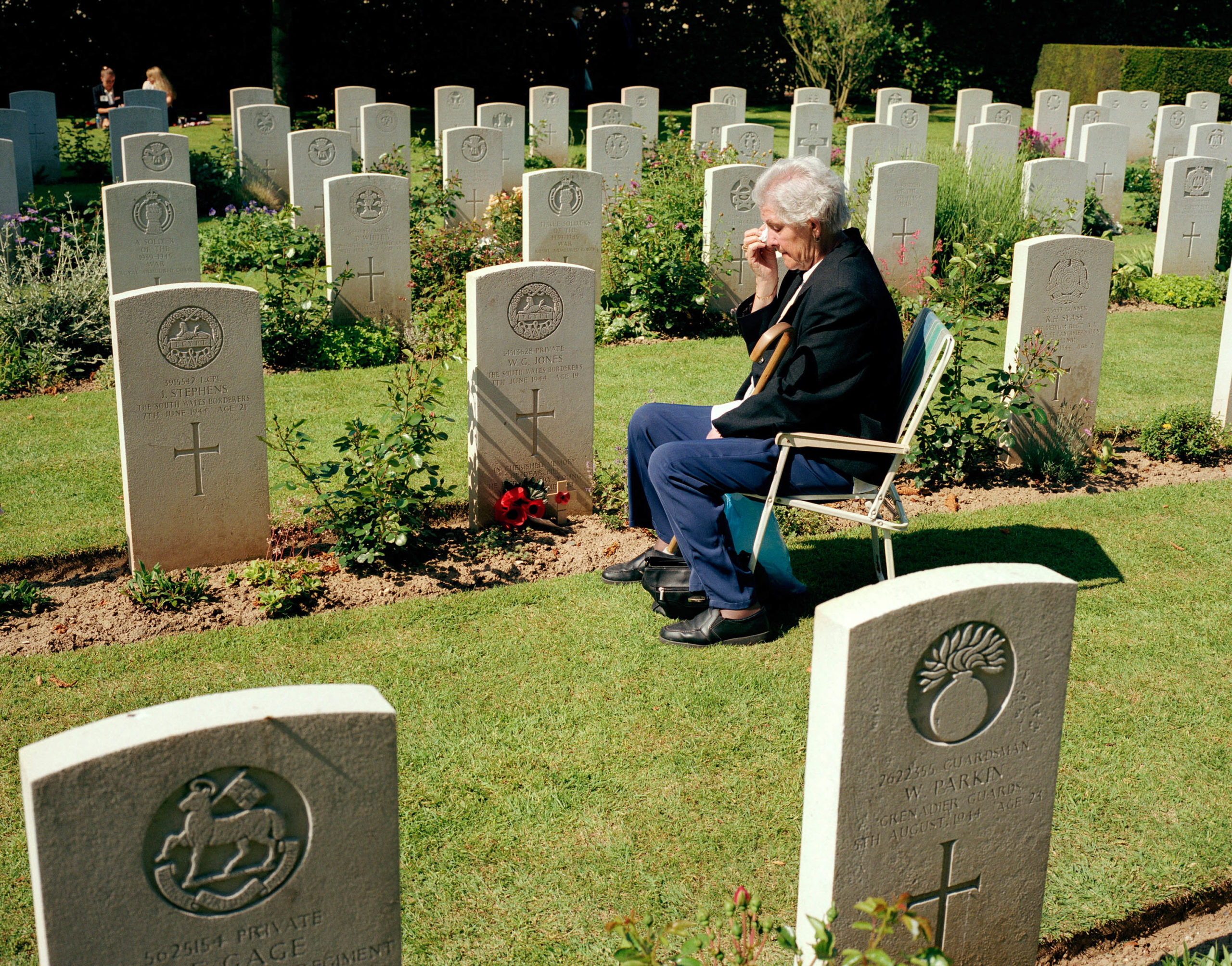 Normandy, Bayeux. D-Day celebrations. A British woman mourns at the grave of her brother, who was killed on 7 June 1944. 