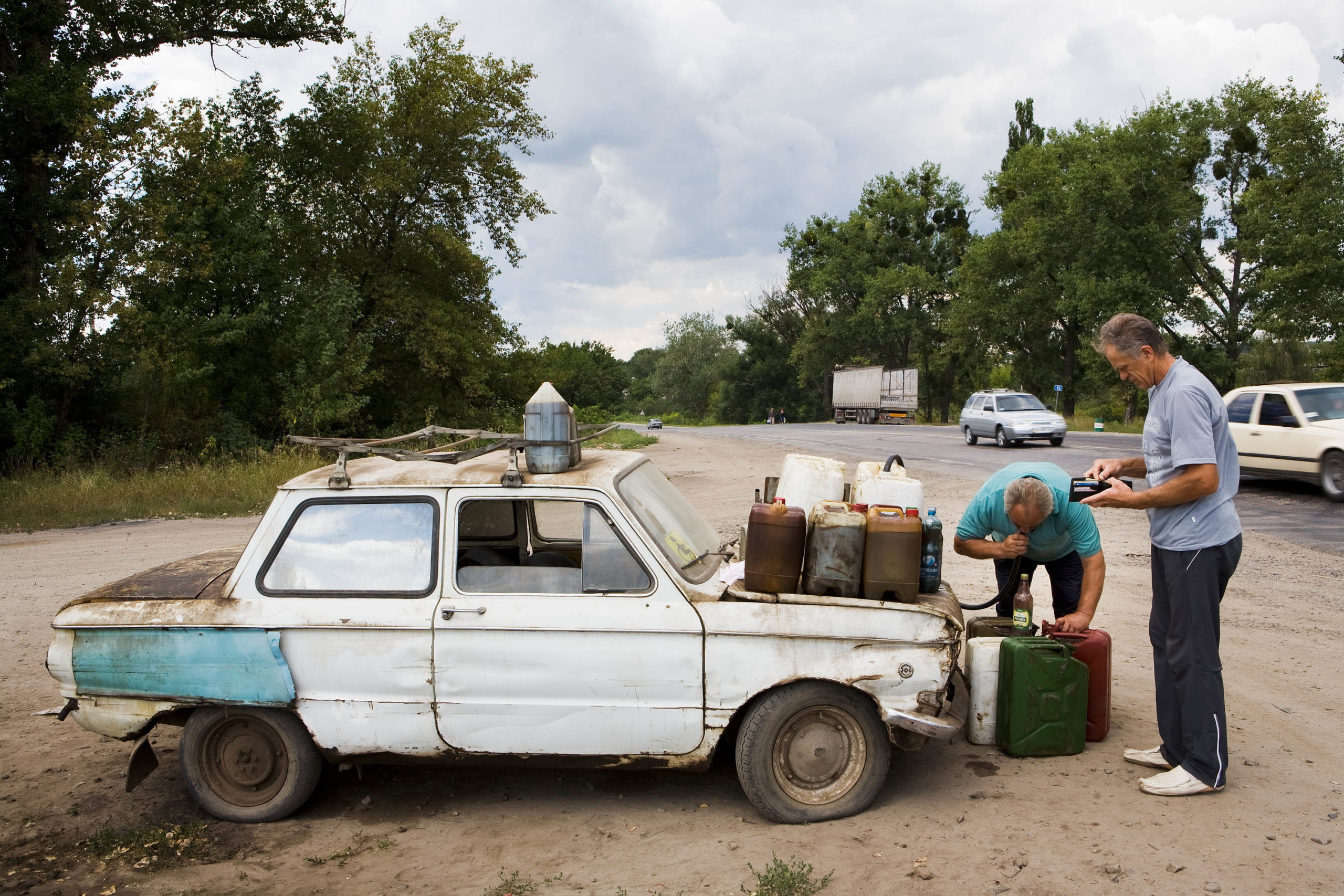 Zaporozhets; Leonti Michailovitsj sells stolen diesel from his car. Karatsjivka, Ukraine, 2008